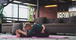 Hard yoga exercises in the morning attractive young lady practicing to stretching the body , for energy and for a health stock footage Hard yoga exercises in the morning attractive young lady practicing to stretching the body , for energy and for a health stock footage