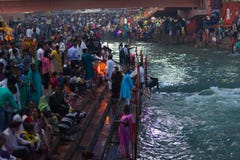Haridwar, India - March 20, 2017: Holy ghats at Haridwar, India, sacred town for Hindu religion. Pilgrims offering floating flowe Royalty Free Stock Photo Haridwar, India - March 20, 2017: Holy ghats at Haridwar, India, sacred town for Hindu religion. Pilgrims offering floating flowe Royalty Free Stock Photo