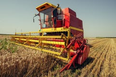 Harvester harvests wheat on field stock photography Harvester harvests wheat on field stock photography