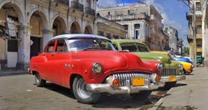 Havana street with colorful old cars in a raw