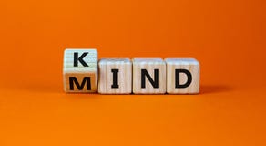 Have a kind mind. Turned cubes and changed the word `kind` to `mind` on a beautiful orange background. Business and kind mind