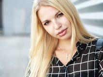 Headshot of young beautiful excited woman with gorgeous natural lips, blue and brown eyes in black blouse on urban metal strips ba Royalty Free Stock Image Headshot of young beautiful excited woman with gorgeous natural lips, blue and brown eyes in black blouse on urban metal strips ba Royalty Free Stock Image