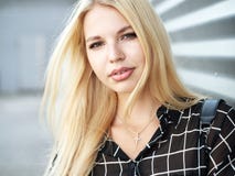 Headshot of young beautiful excited woman with gorgeous natural lips, blue and brown eyes in black blouse on urban metal strips ba Stock Photography Headshot of young beautiful excited woman with gorgeous natural lips, blue and brown eyes in black blouse on urban metal strips ba Stock Photography