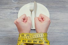 Health body care unhealthy eating dieting starving weight loss slimming. Concept of bad food habbits and unhealthy eating. Woman`