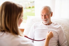 Health visitor and a senior man during home visit. Stock Image Health visitor and a senior man during home visit. Stock Image