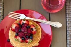 Healthy breakfast on garden furniture: cottage cheese with sour cream, strawberry, raspberry and blueberry, pancakes, yogurt Royalty Free Stock Image Healthy breakfast on garden furniture: cottage cheese with sour cream, strawberry, raspberry and blueberry, pancakes, yogurt Royalty Free Stock Image