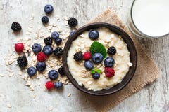 Healthy breakfast. oatmeal porridge in a bowl with glass of milk