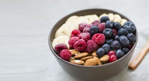 Healthy Breakfast With Acai Bowl, Raspberries, Blueberries, Almonds, Bananans , Healthy Granola Or Muesli Bowl With Fresh Berries Stock Photo
