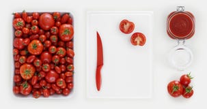 Healthy eating concept many fresh tomatoes with sauce in jar glass, cutting board on kitchen white worktop, copy space, top view royalty free stock images Healthy eating concept many fresh tomatoes with sauce in jar glass, cutting board on kitchen white worktop, copy space, top view royalty free stock images