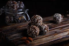 Healthy energy organic vegetarian bites with nuts, dates, honey and sesame on a dark wooden background stock photo Healthy energy organic vegetarian bites with nuts, dates, honey and sesame on a dark wooden background stock photo