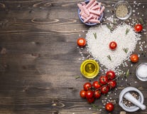 Healthy foods, cooking and concept risotto with ham, oil, cherry tomatoes, rice tiled heart, valentines day border ,place text