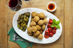Healthy Italian Appetizer Tray with Risotto balls Arancini , Green Olives , Tomato and red Wine. Party Celebration Wedding stock image Healthy Italian Appetizer Tray with Risotto balls Arancini , Green Olives , Tomato and red Wine. Party Celebration Wedding stock image