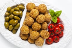 Healthy Italian Appetizer Tray with Risotto balls Arancini , Green Olives , Tomato and red Wine. Party Celebration Wedding royalty free stock photo Healthy Italian Appetizer Tray with Risotto balls Arancini , Green Olives , Tomato and red Wine. Party Celebration Wedding royalty free stock photo