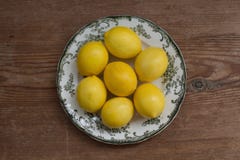 Healthy lifestyle concept. Lemons on a white plate over rustic table stock photography Healthy lifestyle concept. Lemons on a white plate over rustic table stock photography