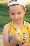 Healthy little boy eating banana. Happy kid enjoy eating fresh fruit. Royalty Free Stock Photography Healthy little boy eating banana. Happy kid enjoy eating fresh fruit. Royalty Free Stock Photography