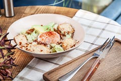 Healthy salad with baked chicken breast, poached egg, lettuce, cheese, avocado. Dieting food. Served salad in bowl on wooden table stock images Healthy salad with baked chicken breast, poached egg, lettuce, cheese, avocado. Dieting food. Served salad in bowl on wooden table stock images