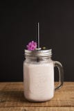 Healthy strawberry smoothie or drink yogurt in a mason a jar glass with berries and mint, over a rustic wood table and black backg royalty free stock images Healthy strawberry smoothie or drink yogurt in a mason a jar glass with berries and mint, over a rustic wood table and black backg royalty free stock images