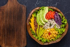 Healthy vegan superfood bowl with quinoa, wild rice, chickpea, tomatoes, avocado, greens, cabbage, lettuce on black stone royalty free stock photos Healthy vegan superfood bowl with quinoa, wild rice, chickpea, tomatoes, avocado, greens, cabbage, lettuce on black stone royalty free stock photos