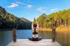 Healthy woman lifestyle balanced practicing meditate and zen energy yoga on the bridge in morning the nature. royalty free stock photography Healthy woman lifestyle balanced practicing meditate and zen energy yoga on the bridge in morning the nature. royalty free stock photography