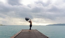 Healthy woman lifestyle balanced yoga practicing meditate and energy on the bridge in morning the seashor Stock Images Healthy woman lifestyle balanced yoga practicing meditate and energy on the bridge in morning the seashor Stock Images