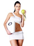 Healthy Woman Stands With The Scales And Green Apple. Stock Image Healthy Woman Stands With The Scales And Green Apple. Stock Image