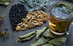 Heart of dried cherries, nuts and dried leaves of tea , side view stock photography Heart of dried cherries, nuts and dried leaves of tea , side view stock photography