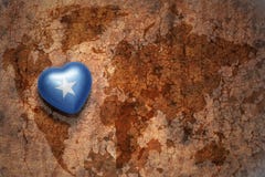 Heart with national flag of somalia on a vintage world map crack paper background. stock image Heart with national flag of somalia on a vintage world map crack paper background. stock image