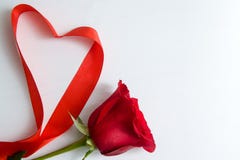 Heart shape made of red ribbon on white wooden Background. copy space - Valentines and 8 March Mother Women&#x27;s Day concept
