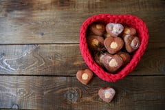 Heart-shaped cookies in a red heart-shaped basket on a wooden background with copy space for text royalty free stock image Heart-shaped cookies in a red heart-shaped basket on a wooden background with copy space for text royalty free stock image