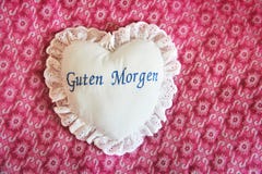 Heart shaped pillow on the bed stock image Heart shaped pillow on the bed stock image