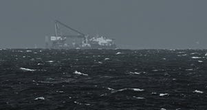 Heavy lift vessel on horizon royalty free stock photography Heavy lift vessel on horizon royalty free stock photography