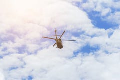 Helicopter flying in the blue sky with beautiful white fluffy clouds background. stock photos Helicopter flying in the blue sky with beautiful white fluffy clouds background. stock photos