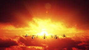 Helicopters against sunset
