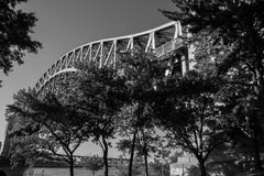 Hell Gate Bridge over the river and trees at Astoria park in black and white style Royalty Free Stock Photography Hell Gate Bridge over the river and trees at Astoria park in black and white style Royalty Free Stock Photography