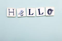 Hello signboard. Handwritten colors letters. Light blue background. stock photography Hello signboard. Handwritten colors letters. Light blue background. stock photography