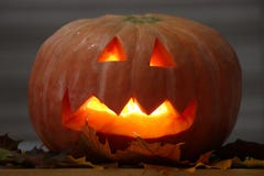 Helloween handmade pumpkin with leaves and candle light. Horror pumpkin stock photo Helloween handmade pumpkin with leaves and candle light. Horror pumpkin stock photo