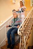 Helps senior old disabled woman to climb the stairs with machin royalty free stock photos Helps senior old disabled woman to climb the stairs with machin royalty free stock photos