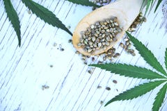 Hemp leaves on wooden background, seeds, cannabis oil extracts in jars Royalty Free Stock Photos Hemp leaves on wooden background, seeds, cannabis oil extracts in jars Royalty Free Stock Photos