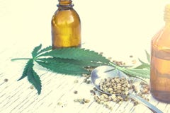 Hemp leaves on wooden background, seeds, cannabis oil extracts in jars Stock Photography Hemp leaves on wooden background, seeds, cannabis oil extracts in jars Stock Photography