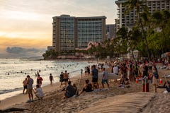 Het iconische Waikiki-Strand bij zonsondergang met een menigte van mensen apprec stock afbeelding Het iconische Waikiki-Strand bij zonsondergang met een menigte van mensen apprec stock afbeelding