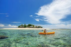 Het jonge vrouw kayaking dichtbij Zuiden Overzees Eiland, Mamanuca-eilanden groepeert zich, Fiji royalty-vrije stock afbeelding Het jonge vrouw kayaking dichtbij Zuiden Overzees Eiland, Mamanuca-eilanden groepeert zich, Fiji royalty-vrije stock afbeelding