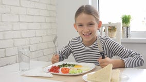 Het kind die Ontbijt in Keuken, Jong geitje eten eet Gezonde Voedseleieren, Meisjesgroenten stock foto's Het kind die Ontbijt in Keuken, Jong geitje eten eet Gezonde Voedseleieren, Meisjesgroenten stock foto's
