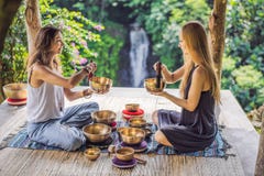 Het koper zingende kom van Nepal Boedha bij kuuroordsalon Jonge mooie vrouw die de zingende kommen van de massagetherapie in het royalty-vrije stock afbeelding Het koper zingende kom van Nepal Boedha bij kuuroordsalon Jonge mooie vrouw die de zingende kommen van de massagetherapie in het royalty-vrije stock afbeelding