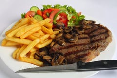 Het lapje vleesdiner van Ribeye met mes stock fotografie Het lapje vleesdiner van Ribeye met mes stock fotografie