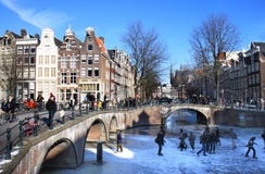 Het schaatsen dichtbij de kruising van twee kanalen in Amsterdam stock fotografie Het schaatsen dichtbij de kruising van twee kanalen in Amsterdam stock fotografie
