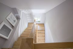High angle on posters and wooden stairs in the hall of house int royalty free stock images High angle on posters and wooden stairs in the hall of house int royalty free stock images