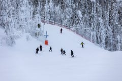 High angle view of people on a skiing slope. Ski sports and snowboarding in Finland