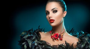 High Fashion Model Girl Portrait with Trendy gothic make-up, Black Hair style, Make up, dark accessories over black background