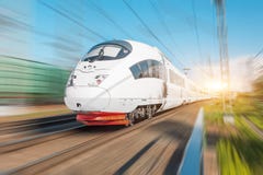 High Speed Electric Train Passenger Rides At High Speed At The Railway Station In The City. Stock Photo