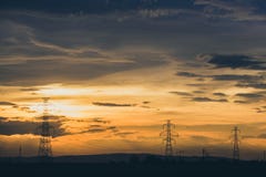High voltage electic pylon line on party cloud sunset stock photography High voltage electic pylon line on party cloud sunset stock photography